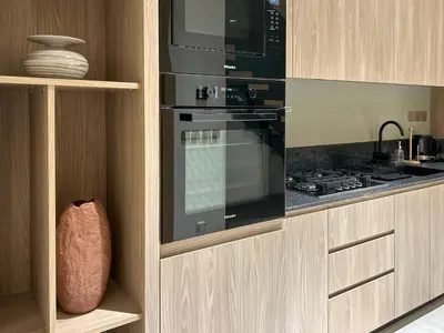 a kitchen with a stove and a microwave at Bespoke Holiday Homes - Stylish 1BR Penthouse in The Autograph in Dubai