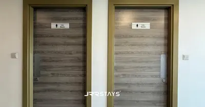 two metal doors in a building with signs on them at Elegant Luxury 1BR - Modern Design - JVC in Dubai