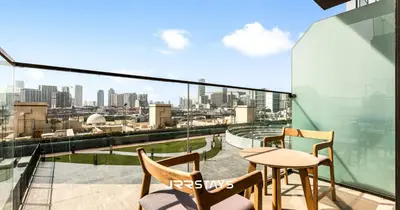 a balcony with a view of a city skyline at Elegant Luxury 1BR - Modern Design - JVC in Dubai
