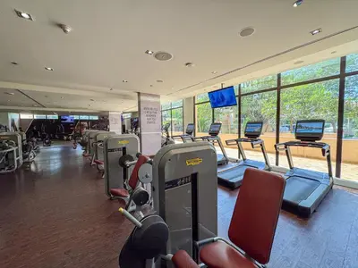 a gym with a row of treadmills and machines at Homely 1 Bedroom on Palm Jumeirah with private beach in Dubai