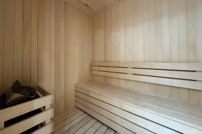 a sauna with wooden shelves and wooden floors at Stylish Studio with Jacuzzi in Business Bay in Dubai