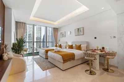 a white bedroom with a bed and a table at LUX New Studio With 2 Double Beds in Downtown Dubai, Pool View, Free Parking in Dubai