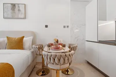 a bedroom with a bed and a small table with cups on it at LUX New Studio With 2 Double Beds in Downtown Dubai, Pool View, Free Parking in Dubai
