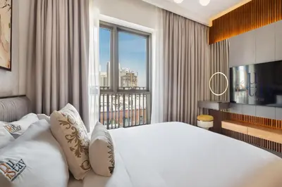 a hotel room with a bed and a large window at qua Serenity Poolside with Community Views in Dubai
