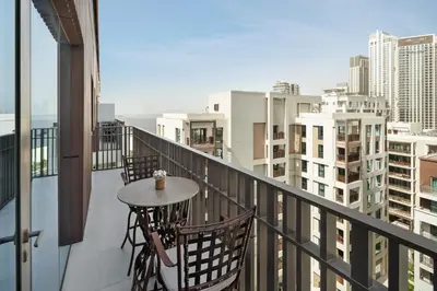 a balcony with a table and chairs on a balcony at qua Serenity Poolside with Community Views in Dubai