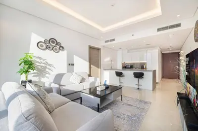 a living room with a couch and a table at Luxe 1BR Burj View 10 min Walk to Dubai Mall in Dubai