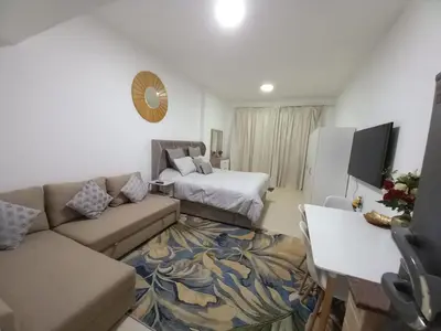 a living room with a couch and a bed at Diamond Studio Marina in Dubai
