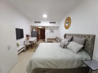 a bedroom with a bed and a living room at Diamond Studio Marina in Dubai