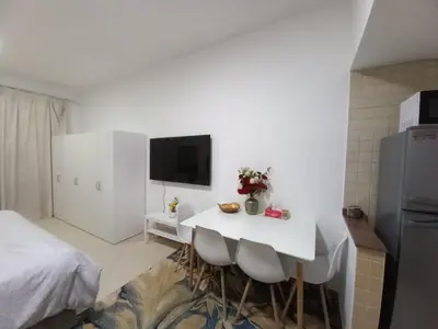a white room with a white table and a bed at Diamond Studio Marina in Dubai
