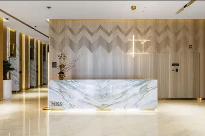 a lobby with a large marble table in a room at Mahogany 10 - 2BR 8 PAX - Infinity Pool & Modern in Dubai