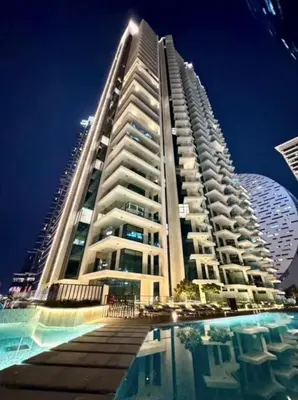 a large building with a pool in front of it at Mahogany 10 - 2BR 8 PAX - Infinity Pool & Modern in Dubai