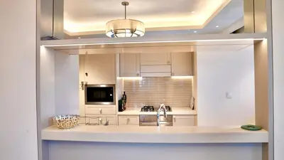 a large kitchen with a sink and a microwave at The Address Fountain Views Residence High Floor with Burj Khalifa view and access to Dubai mall in Dubai