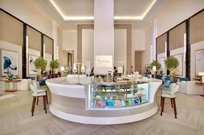 a lobby with a counter in a store with chairs at The Address Fountain Views Residence High Floor with Burj Khalifa view and access to Dubai mall in Dubai