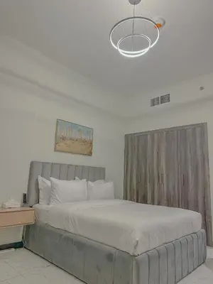 a bedroom with a large bed with a wooden headboard at Studio Apartment in Rukan Wadi Al Safa by the S Holiday Homes in Dubai