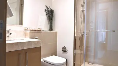 a bathroom with a shower and a toilet and a sink at Luxe Dubai Marina Apartment 5242 Building 2bhk in Dubai