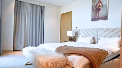 a bedroom with a large bed and a window at Luxe Dubai Marina Apartment 5242 Building 2bhk in Dubai