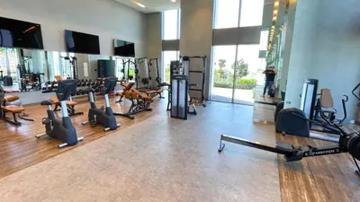 a gym with several treadmills and machines in a room at Luxe Dubai Marina Apartment 5242 Building 2bhk in Dubai