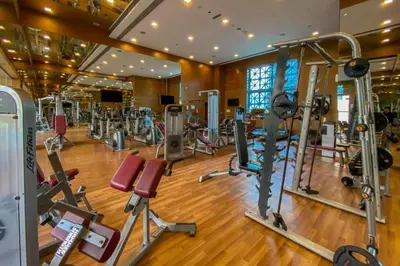 a gym with lots of cardio equipment in a building at City View Studio, Minutes Away from Dubai Opera, Burj Khalifa and Dubai Mall, Claren Tower 2, Downtown Dubai by Deluxe Holiday Homes in Dubai