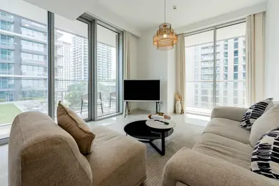 a living room with a couch and a flat screen tv at TRPS - Beach Isle Tower 1, Dubai Harbour - 1BR Premium Beachfront - Private Beach Access in Dubai