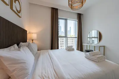 a bedroom with a large white bed with towels on it at TRPS - Beach Isle Tower 1, Dubai Harbour - 1BR Premium Beachfront - Private Beach Access in Dubai
