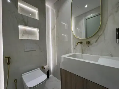 a bathroom with a sink and a toilet and a mirror at A unique luxury touch in JLT in Dubai