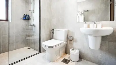 a bathroom with a toilet and a sink and a shower at Trophy-Lux Villa w Big Garden & BBQ Grill in Dubai