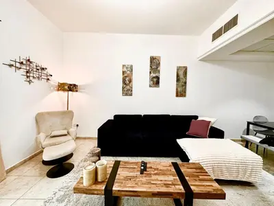 a living room with a couch and a table at Chic 1BR with the City Views in Dubai