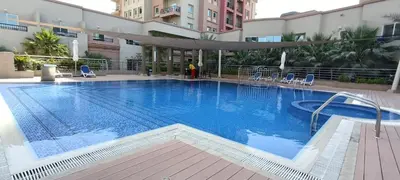 a large swimming pool in a hotel with chairs at Chic 1BR with the City Views in Dubai