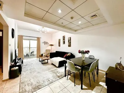 a living room with a table and a couch at Chic 1BR with the City Views in Dubai