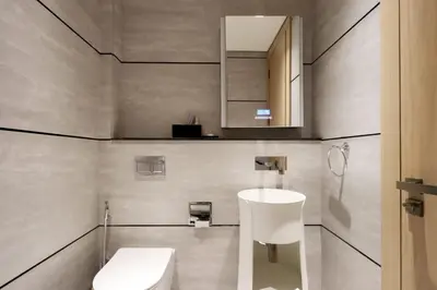 a bathroom with a white toilet and a sink at Livbnb - Stylish Studio in JVC, Near Parks and Shops in Dubai
