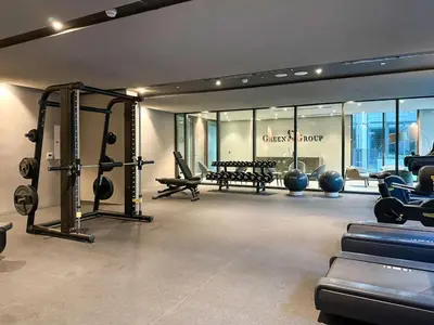 a gym with treadmills and machines in a room at Livbnb - Stylish Studio in JVC, Near Parks and Shops in Dubai