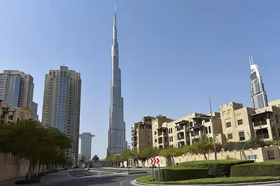 a street in a city with a tall building at Cozy 1BR Apart Downtown Burj Khalifa and Dubai Mall in Dubai