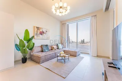 a living room with a couch and a large window at High-Rise 1BR with Stunning Creek Views,Near to Dubai Creek Tower Viewpoint, Harbour Gate Tower 2, Dubai Creek Harbour by Deluxe Holiday Homes in Dubai