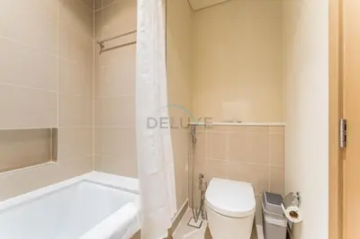 a bathroom with a tub and a toilet and a shower at High-Rise 1BR with Stunning Creek Views,Near to Dubai Creek Tower Viewpoint, Harbour Gate Tower 2, Dubai Creek Harbour by Deluxe Holiday Homes in Dubai