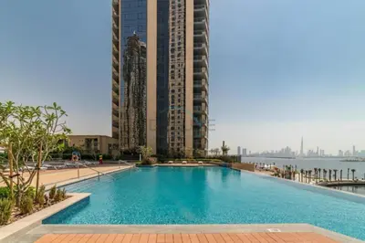 a large swimming pool with tall buildings in the background at High-Rise 1BR with Stunning Creek Views,Near to Dubai Creek Tower Viewpoint, Harbour Gate Tower 2, Dubai Creek Harbour by Deluxe Holiday Homes in Dubai