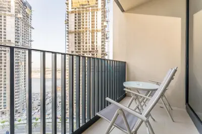 a balcony with a table and chairs and a view of the city at High-Rise 1BR with Stunning Creek Views,Near to Dubai Creek Tower Viewpoint, Harbour Gate Tower 2, Dubai Creek Harbour by Deluxe Holiday Homes in Dubai