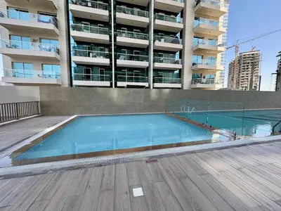 an empty swimming pool in front of a building at FIRST CLASS 2BR Sleek Urban Oasis in Dubai