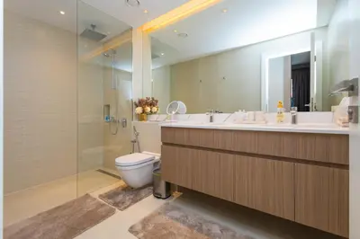 a bathroom with a toilet and a sink and a mirror at 2BR by Sea, 15min to Dubai Mall in Dubai