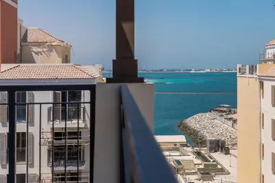 a view of the ocean from a balcony of a building at 2BR by Sea, 15min to Dubai Mall in Dubai