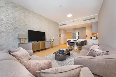 a living room with two couches and a flat screen tv at 2BR by Sea, 15min to Dubai Mall in Dubai