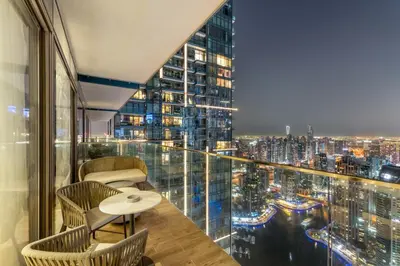 a room with a view of a city at night at 1BR Jumeirah Living - Marina View - 5 STARS Facilities in Dubai