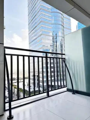 a balcony with a view of a tall building at Canal Luxe Burj 1BR Sleeps 4 with Pool and Gym in Dubai