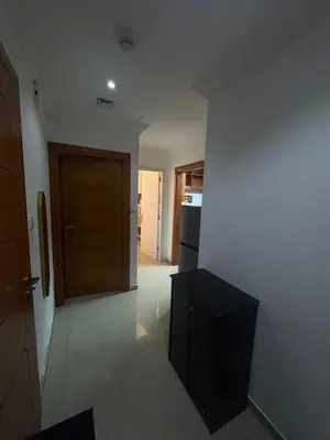 a kitchen with a brown door and a black cabinet at Dream home in Dubai