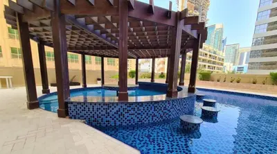 a swimming pool with a gazebo in a building at Dream home in Dubai