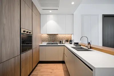 a kitchen with white cabinets and a sink at The Marina Observatory-Jumeirah Living Marina Gate in Dubai
