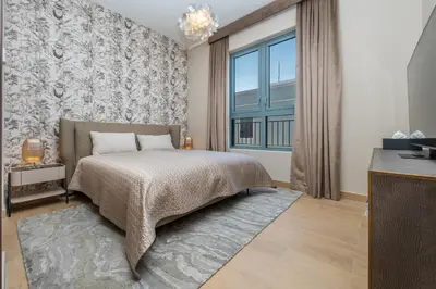a bedroom with a bed and a large window at WOW Port de la Mer Skyline Blick Dubai in Dubai