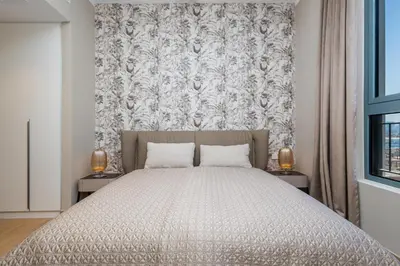 a bedroom with a large bed with two night stands at WOW Port de la Mer Skyline Blick Dubai in Dubai
