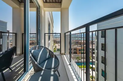 a balcony with a chair and a view of the city at WOW Port de la Mer Skyline Blick Dubai in Dubai