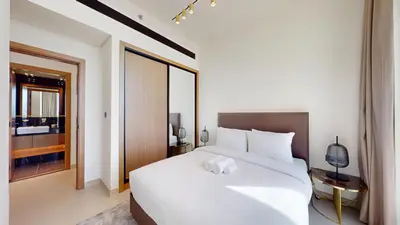 a bedroom with a large white bed and a window at Binghatti House - Two Bedroom with Private Pool in Dubai