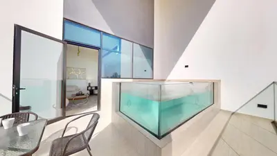 an aquarium in a room with a table and chairs at Binghatti House - Two Bedroom with Private Pool in Dubai